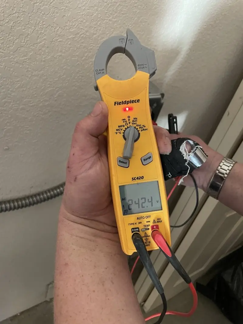 Voltage testing with clamp meter during Recessed Lighting Installation in Terre Haute